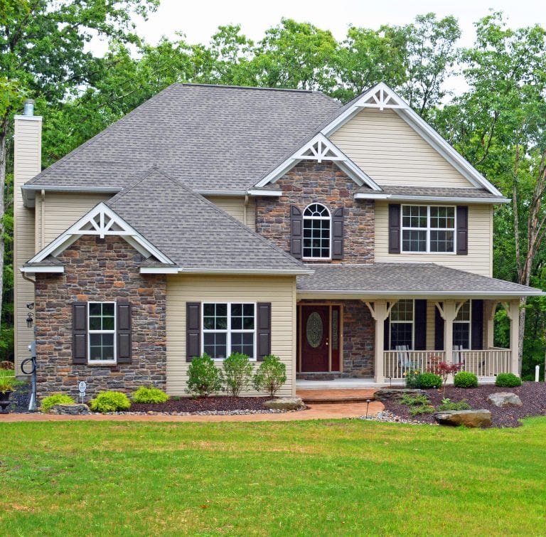 Pocono home exterior with plants and stone siding