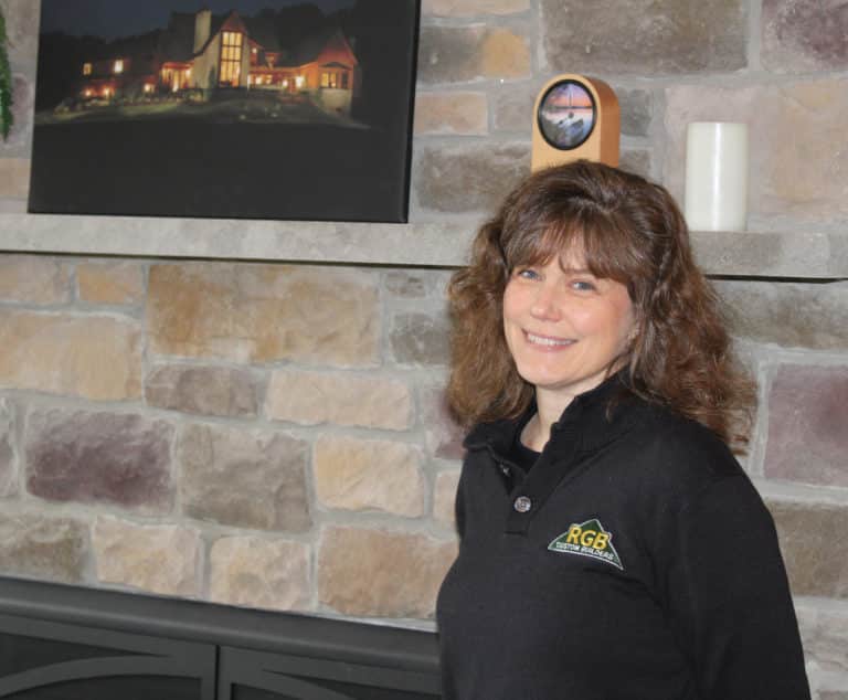 Photo of Josie next to fireplace