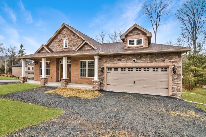 Custom ranch home exterior, 4 pillars at entrance, 2-car garage