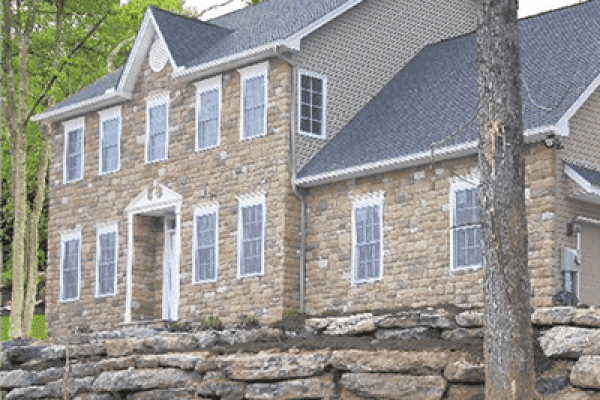 Emerald Award-winning home built by RGB with light brown stone siding