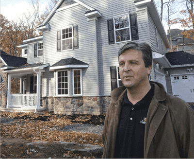 Bob standing in front of award-winning home