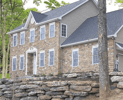 Emerald Award-winning home built by RGB with light brown stone siding